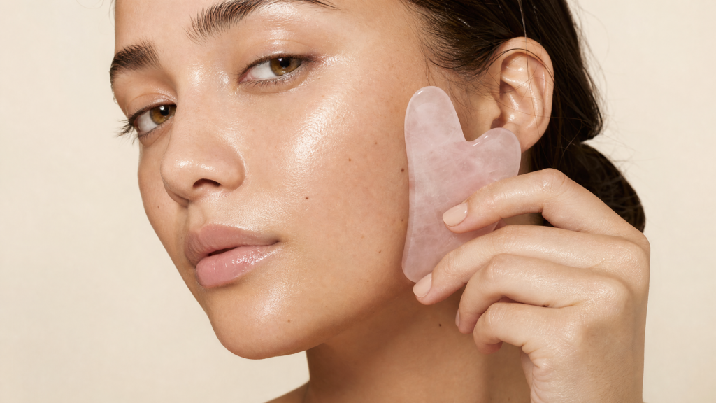 Client practicing an at-home facial massage ritual to maintain dewy glass skin texture.